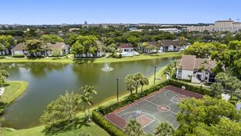 apartment community with a view of a lake and sports court